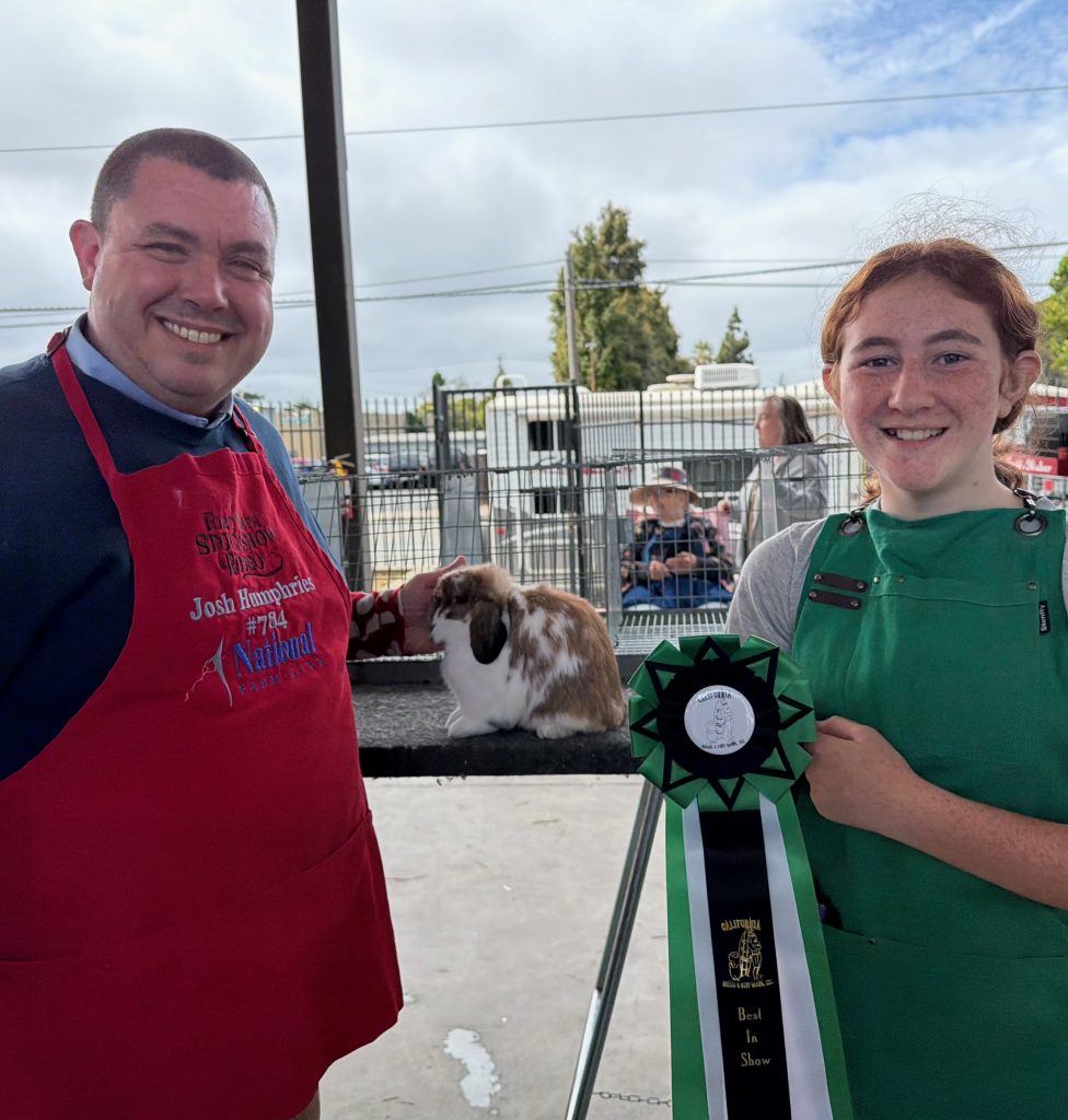 Elliot receiving a Best in Show ribbon